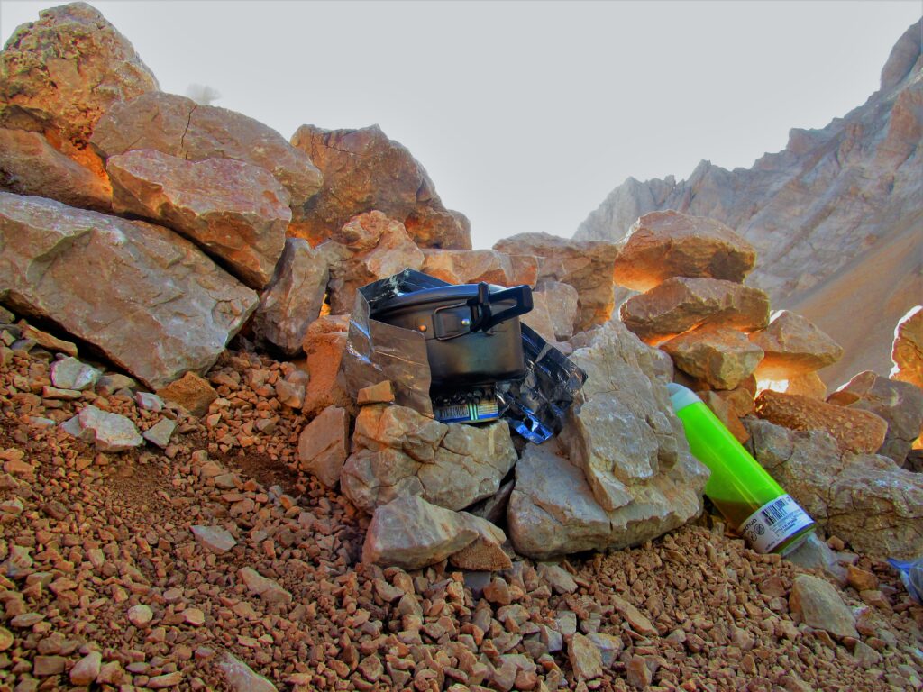 Backpacking in Turkey. An alcohol stove boils water for cooking. The stove is set on rocks.