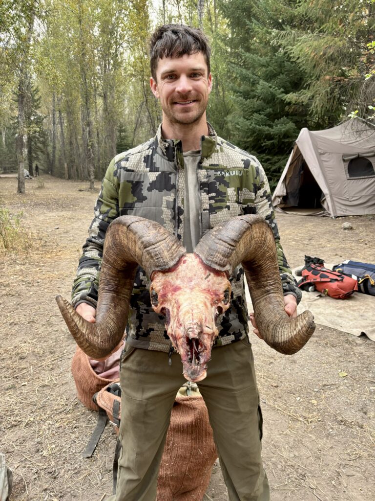 Hunter holding a Rocky Mountain bighorn sheep skull